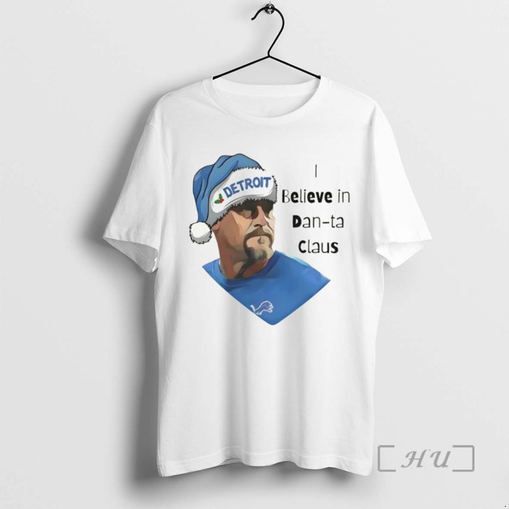 Trending I Believe In Dan Ta Claus Dan Campbell Detroit Lions Football Christmas 2025 Tee